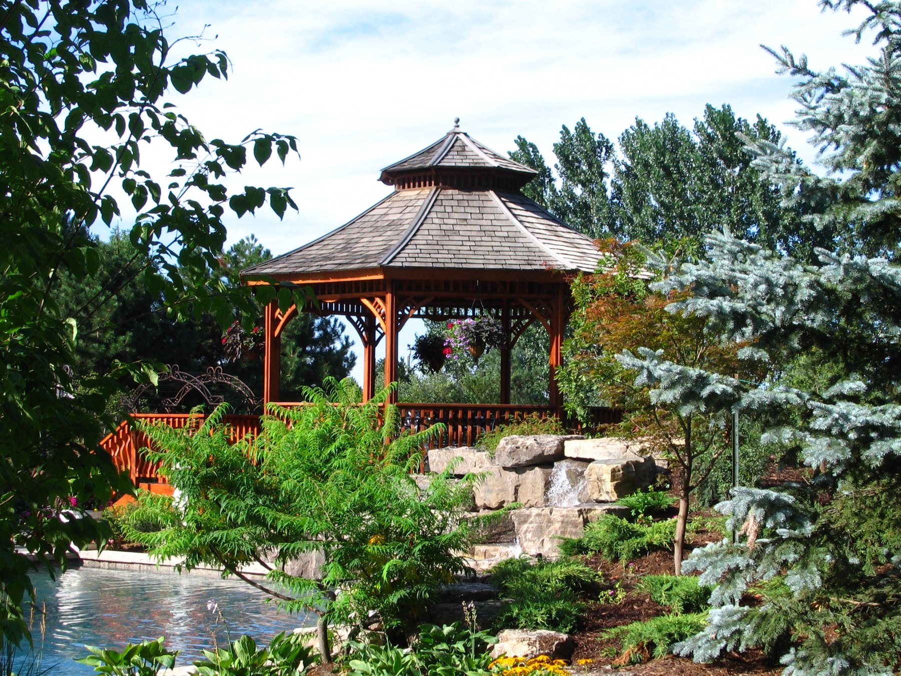 Garden pavilion, pond, and layered planting