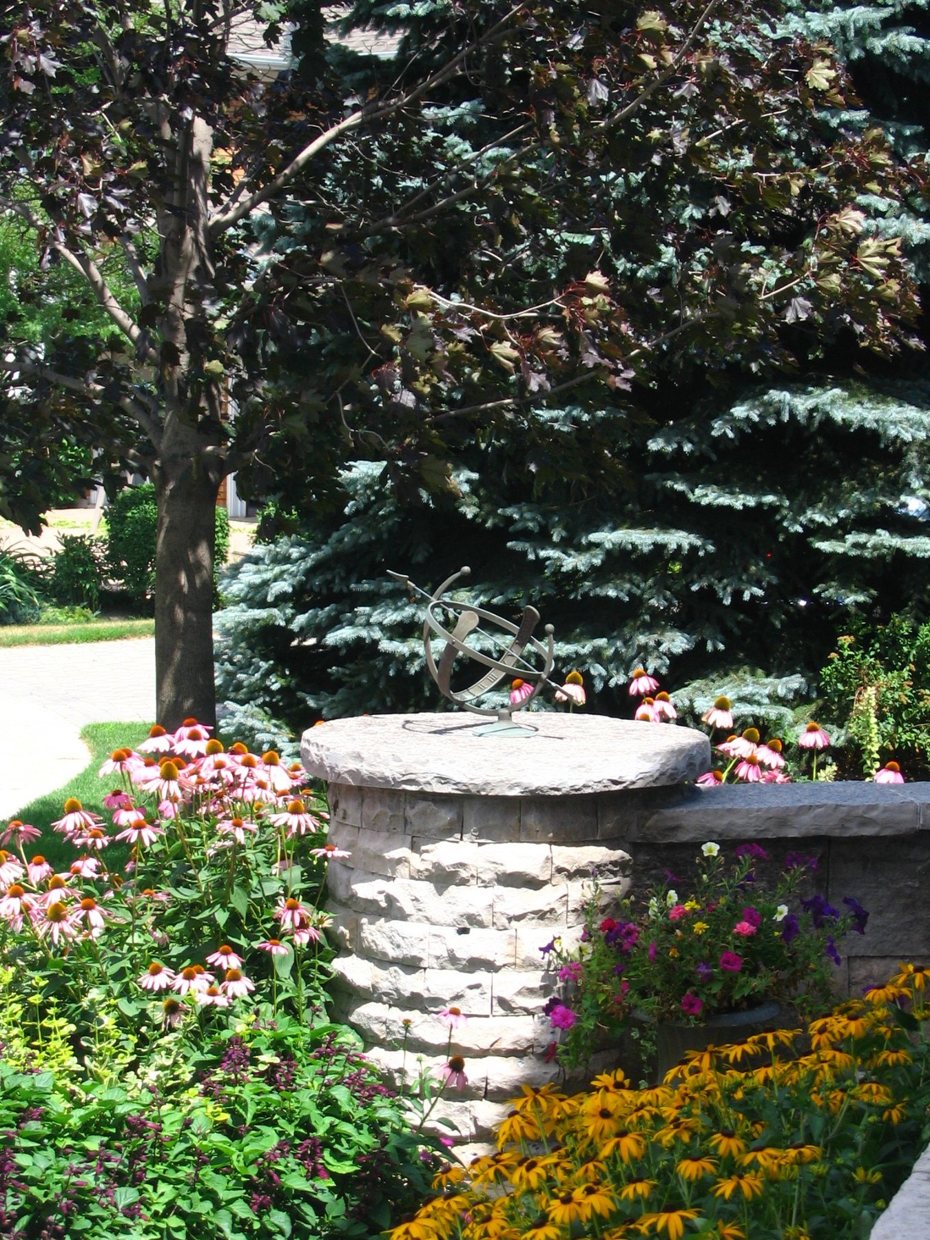 Natural stone bench beside a garden entry